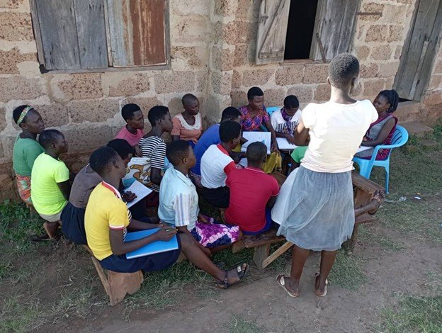 Acan Zerah with youth at health facility (replace with actual photo)